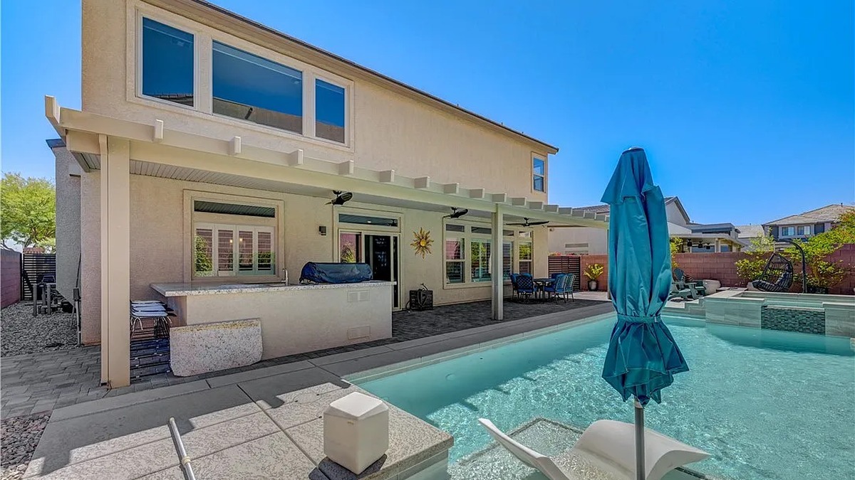 Backyard outdoor kitchen and covered patio at Las Vegas luxury home for sale